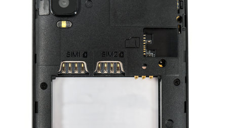 Slot for dual SIM cards and sd card, on a cell phone, mobile phone, smartphone close-up macro detail, isolated over white backgroundの写真素材