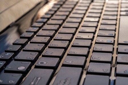 Close-up electronic of laptop keyboard with focus on W button, copy spaceの写真素材