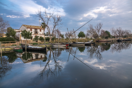 Albufera nature reserve in Catarroja Valencia Spain old traditional wooden boats. Latin sailing ships, in the harborの写真素材