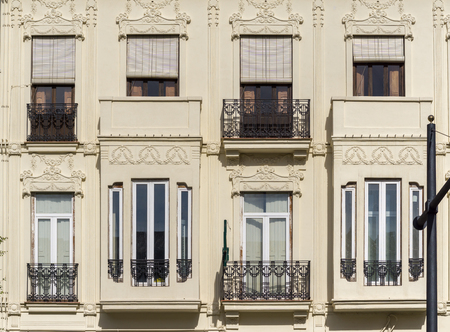 Architecture of Classical Building Facade on Old Historical House. Exterior of White Color Apartment Building Front View. Minimalist European Style Architecture on Sunny Day.の写真素材