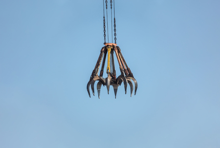 concept of catching, hook to get something, crane hook isolated on sky background copy spaceの写真素材