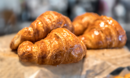 sweet pastry croissant exposed in a store, bakery Croissant for an appetizing breakfastの写真素材