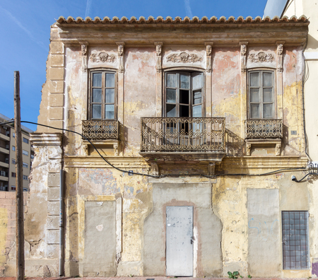 facade of small old house in a traditional neighborhood of Valencia Spain architecture of Classical Building Historical House. Exterior abandoned, uninhabited Apartment Buildingの写真素材
