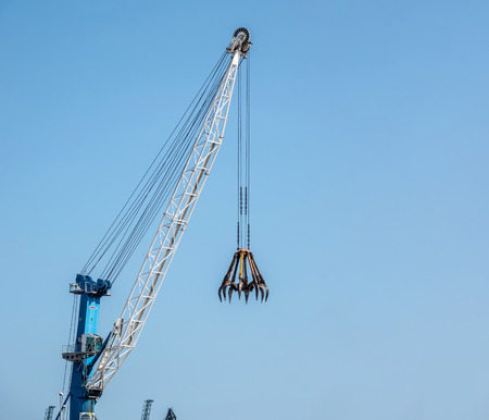 Big construction crane on blue sky background copy spaceの写真素材