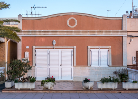 typical mediterranean house Spain coast town, facade of single-story dwellingの写真素材