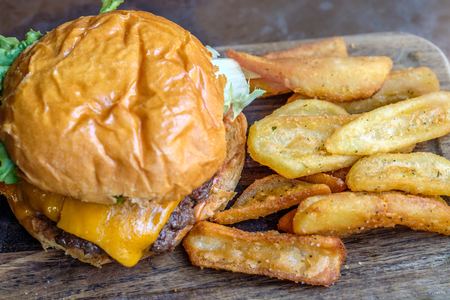 cheeseburger top view, burger and french fries on wooden tableの写真素材