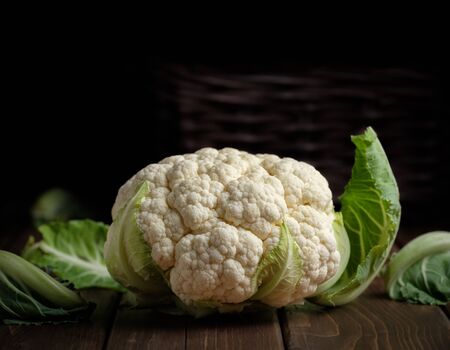 vegetable cauliflower head fresh raw vegan food ingredient still life dark wood background with copy spaceの写真素材