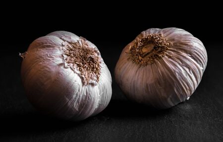 garlic chiaroscuro isolated on a black background cooking dark closeup macroの写真素材