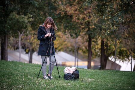 woman traveler landscape photography with mirrorless camera travel night photo with tripod to avoid shakeの写真素材