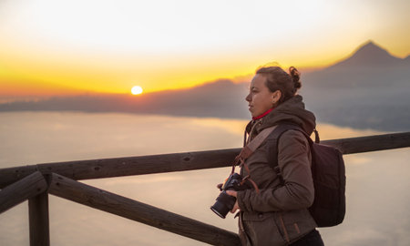woman traveler sunset landscape photography with bridge camera travel photo