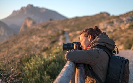 woman traveler landscape photography with bridge camera travel photoの写真素材