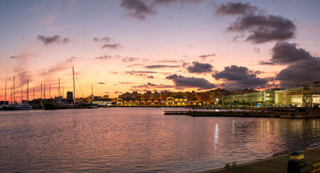 Sunset at the port of Valencia harbor, water reflection marina port nautical sceneの写真素材