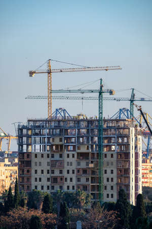 construction of building with cranes with visible internal structureの写真素材