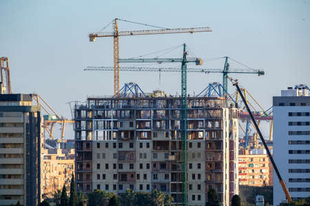 construction of building with cranes with visible internal structureの写真素材