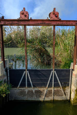 Wooden doors in an irrigation ditch, to control the entry and exit of waterの写真素材