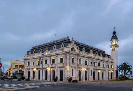 Port Authority building with clock tower in Valencia harbor, Spain night lightsの写真素材