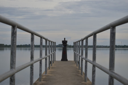 Lighthouse on the pier at the lake in the evening, Thailandの写真素材