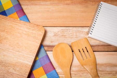 Fork, Knife,notebook diary and Table Cloth on wooden background. Top View with Text Spaceの写真素材