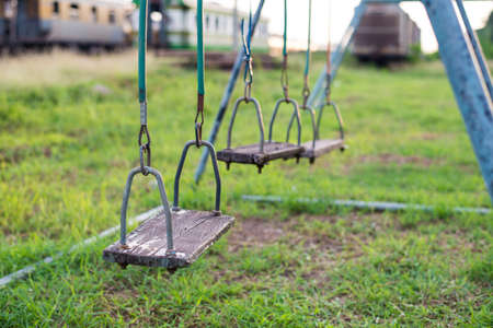 Empty swing on children playground in city.の写真素材