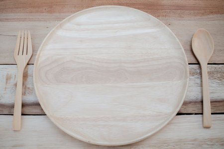 wood dish and wood fork on wooden table and vintage color.with Text Spaceの写真素材