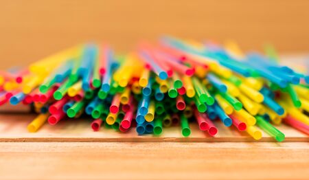 Colorful straw tubes closeup. Abstract texture and background.on wooden tableの写真素材