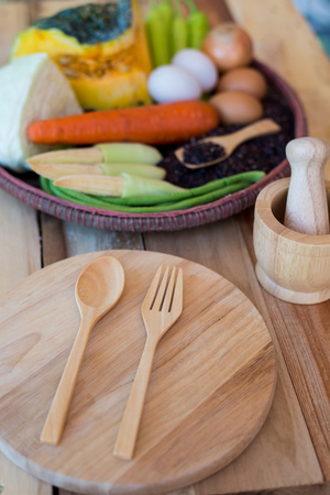 clean food,vegetables set ,wood dish and wood fork on wooden tableの写真素材