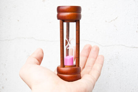 Hand holding hourglassの写真素材
