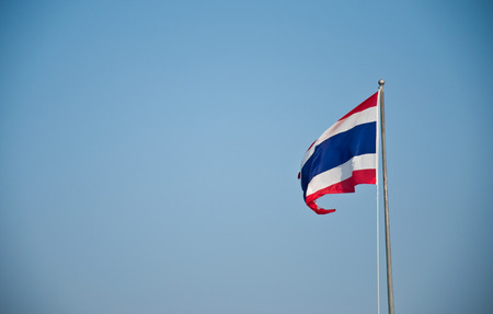 Thai flag on blue sky backgroundの写真素材