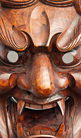 Close up japanese demon mask carving from woodの写真素材