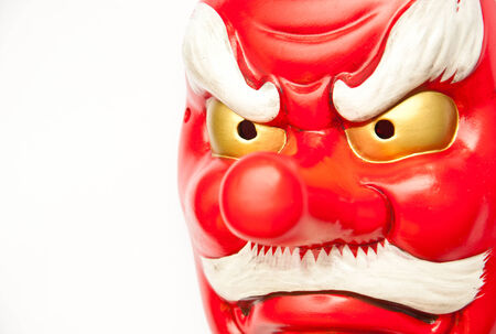 Close up japanese demon mask on white backgroundの写真素材
