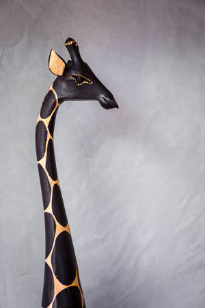 Giraffe Statue with a concrete wall behide.の写真素材