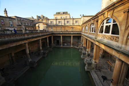 Roman Bath, UK - December 6, 2013: Tourists visiting inside Roman Baths complex. City of Bath is a World Heritage Site. Sepia.のeditorial素材