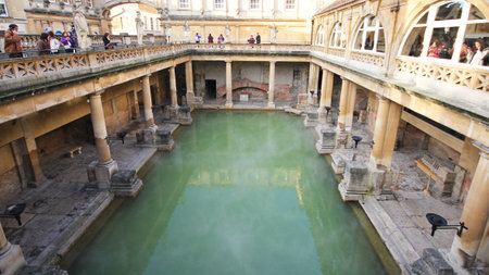 Roman Bath, UK - December 6, 2013: Tourists visiting inside Roman Baths complex. City of Bath is a World Heritage Site. Sepia.のeditorial素材