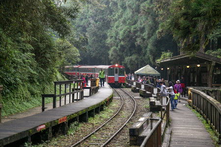 Alishan,taiwan-October 14,2018:Red train stop in foggy day at alishan train station on alishan mountain,taiwan.のeditorial素材