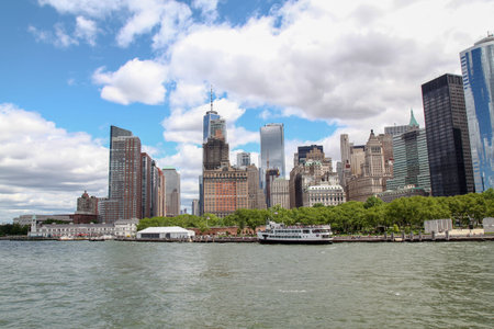 New York,USA-June 15 ,2018 :Look on the sailboat is cruising in New York harbor buildings of Manhattan island in the background.のeditorial素材