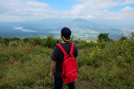 Asia man stand up in front of view of mountain in thailand