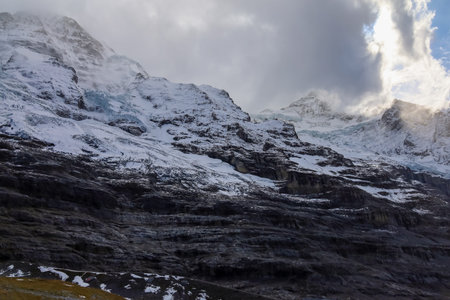 View of alp mountain in autumn have snow on top hill
