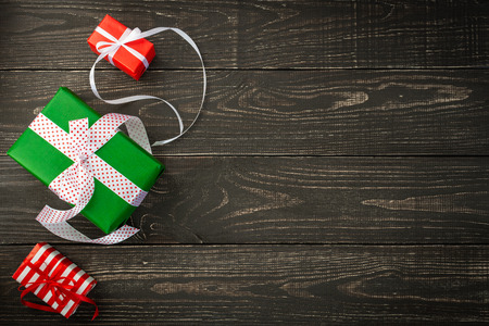 Festive background, gift boxes and ribbons on a brown wooden background, Valentines Day or Christmas or birthdayの写真素材