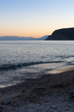 Beautiful sunset on the black sea, evening view of the mountains, Vesele bay in the Sudak Municipality of the Crimeaの写真素材
