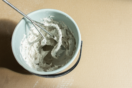 Bucket with ready putty and drill mixerの写真素材