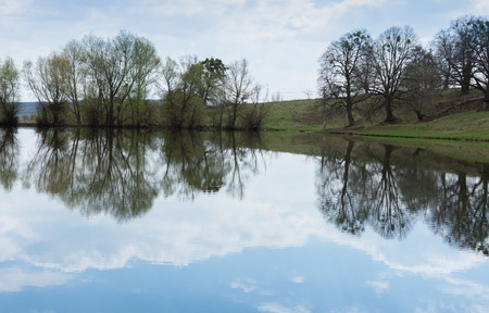Reflection of clouds in a lake on a spring dayの写真素材