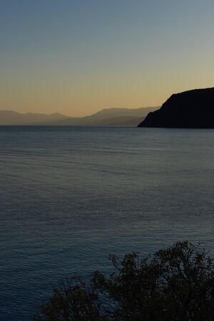 Beautiful sunset on the black sea, evening view of the mountains, Vesele bay in the Sudak Municipality of the Crimeaの写真素材