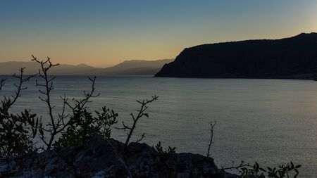 Beautiful sunset on the black sea, evening view of the mountains, Vesele bay in the Sudak Municipality of the Crimeaの写真素材