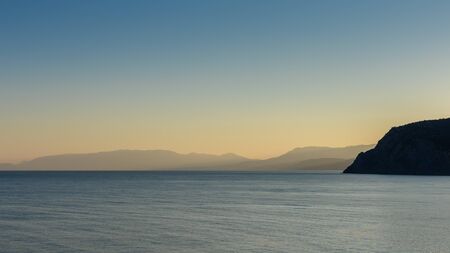 Beautiful sunset on the black sea, evening view of the mountains, Vesele bay in the Sudak Municipality of the Crimeaの写真素材