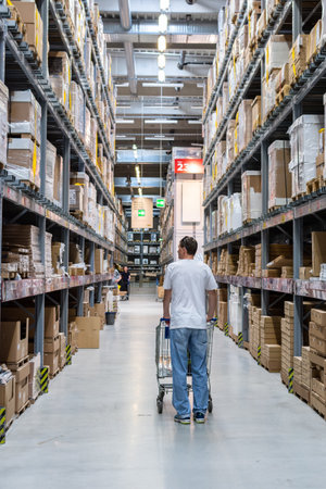 Berlin, Germany- May 24, 2019: Buyer man in store between row of shelves with goods, warehous in Ikeaのeditorial素材