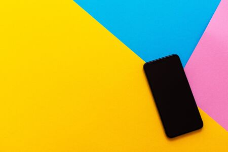 New modern black phone on colorful background, flat lay, copy spaceの写真素材
