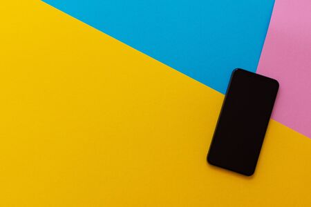 New modern black phone on colorful background, flat lay, copy spaceの写真素材