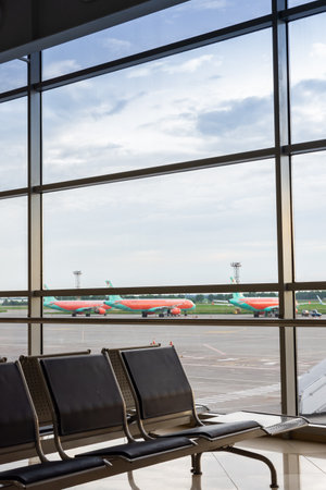 Boryspil, Ukraine - May 22, 2019: waiting hall and runway with airplanes at the Borispol airport , airplanes in front of the terminalのeditorial素材
