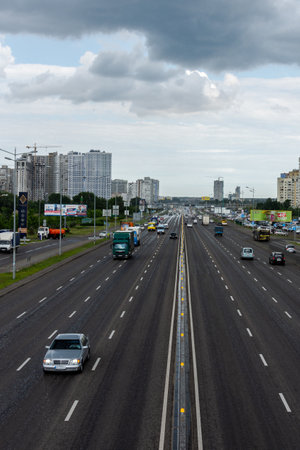 Kiev, Ukraine - May 22, 2019: view to the road to Boryspil in the city of Kiev on a rainy day, road junction neighborhood Poznyakiのeditorial素材