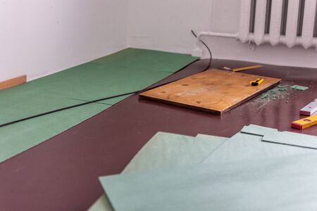 Sheets environmentally friendly underfloor for laminate and parquet , rulers and knife for cutting the underfloor, natural insulation from coniferous speciesの写真素材